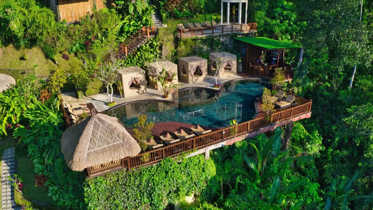 Tropical Bali villa with open living design, outdoor lounge pavilion, infinity pool and jungle landscape