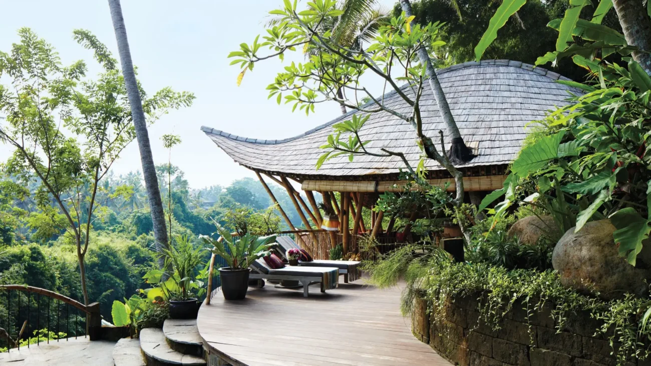 Tropical Bali villa with open living design, outdoor lounge pavilion, infinity pool and jungle landscape