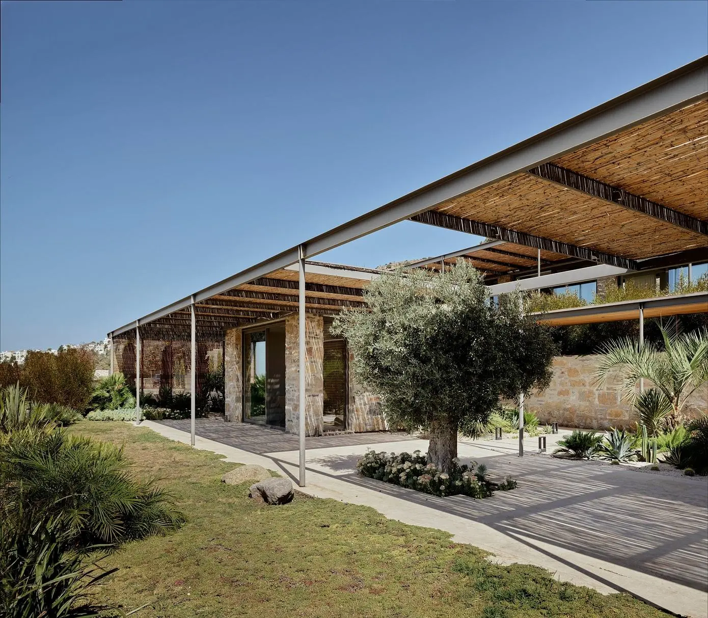 Mediterranean luxury architecture showcasing modern villa design in Bodrum with natural stone, minimal geometry, and seamless integration with coastal landscape