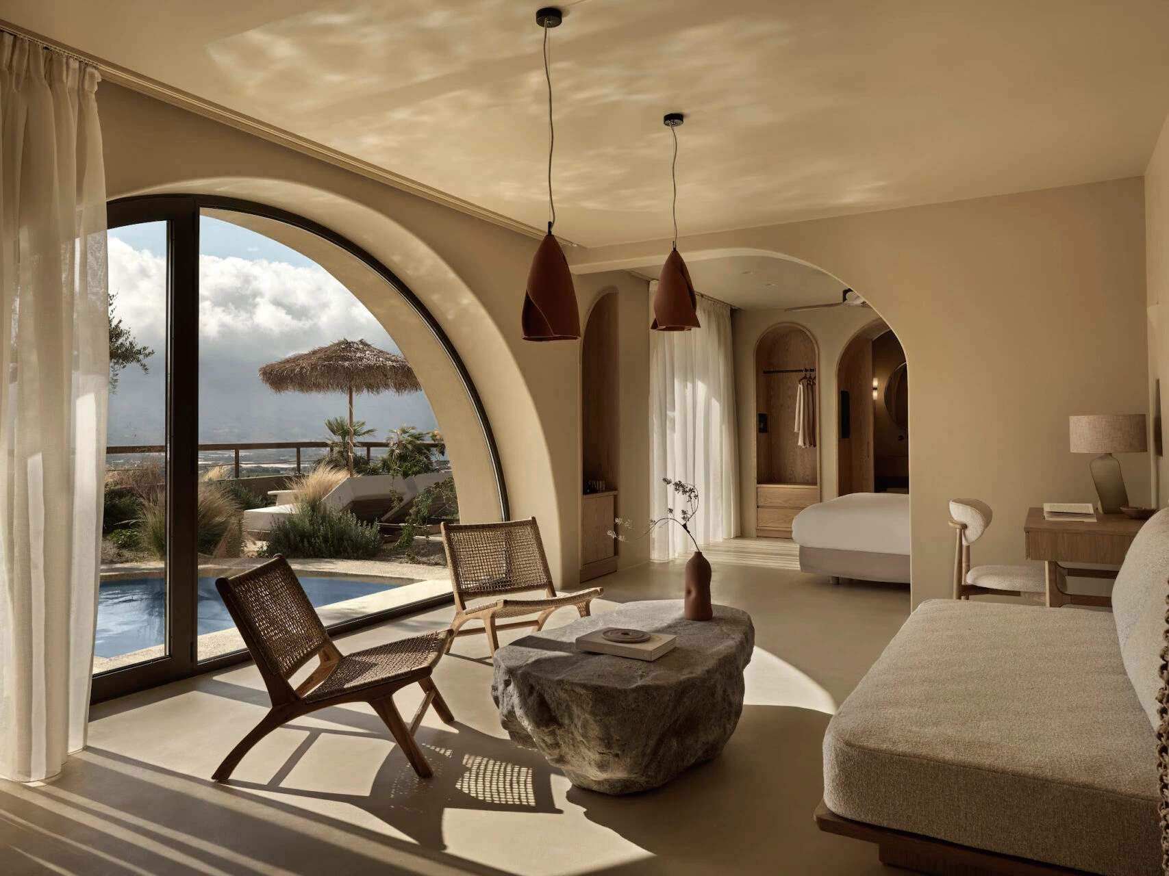 Minimalist Mediterranean interior suite with neutral tones, natural materials, soft textures and warm sunlight creating a calm and elegant atmosphere