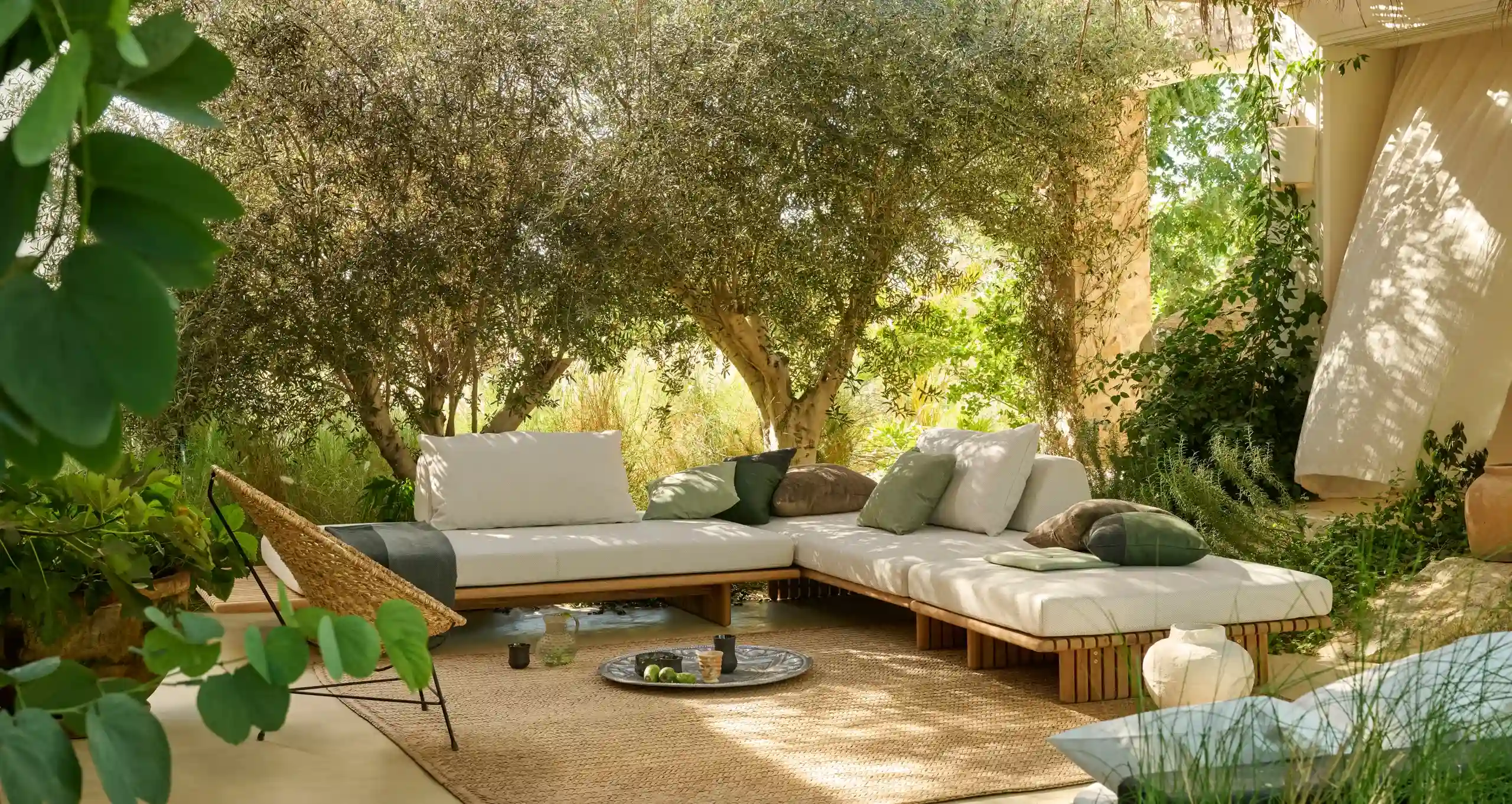 Outdoor luxury living design featuring a contemporary terrace lounge with premium Sunbrella fabric seating, modern cushions, natural lighting, and elegant outdoor lifestyle architecture.