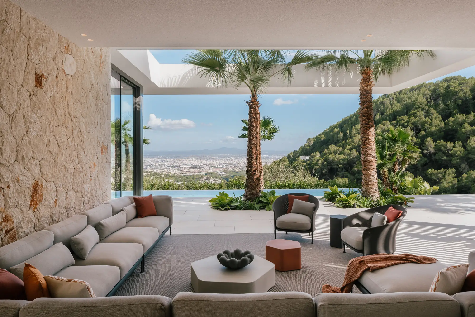 Modern lounge chair made of natural rattan with soft sculptural form, designed for contemporary Mediterranean interiors combining craftsmanship and comfort