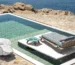 Paola Navone in outdoor Luxury Architecture, with view to a pool and ocean