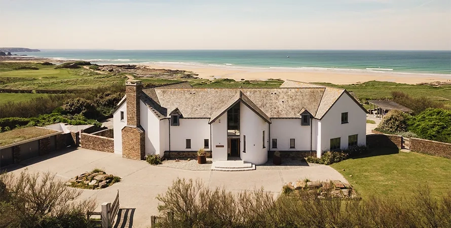 Mediterranean luxury architecture showcased in modern beach house exterior with natural materials, clean lines, and seamless integration with coastal landscape