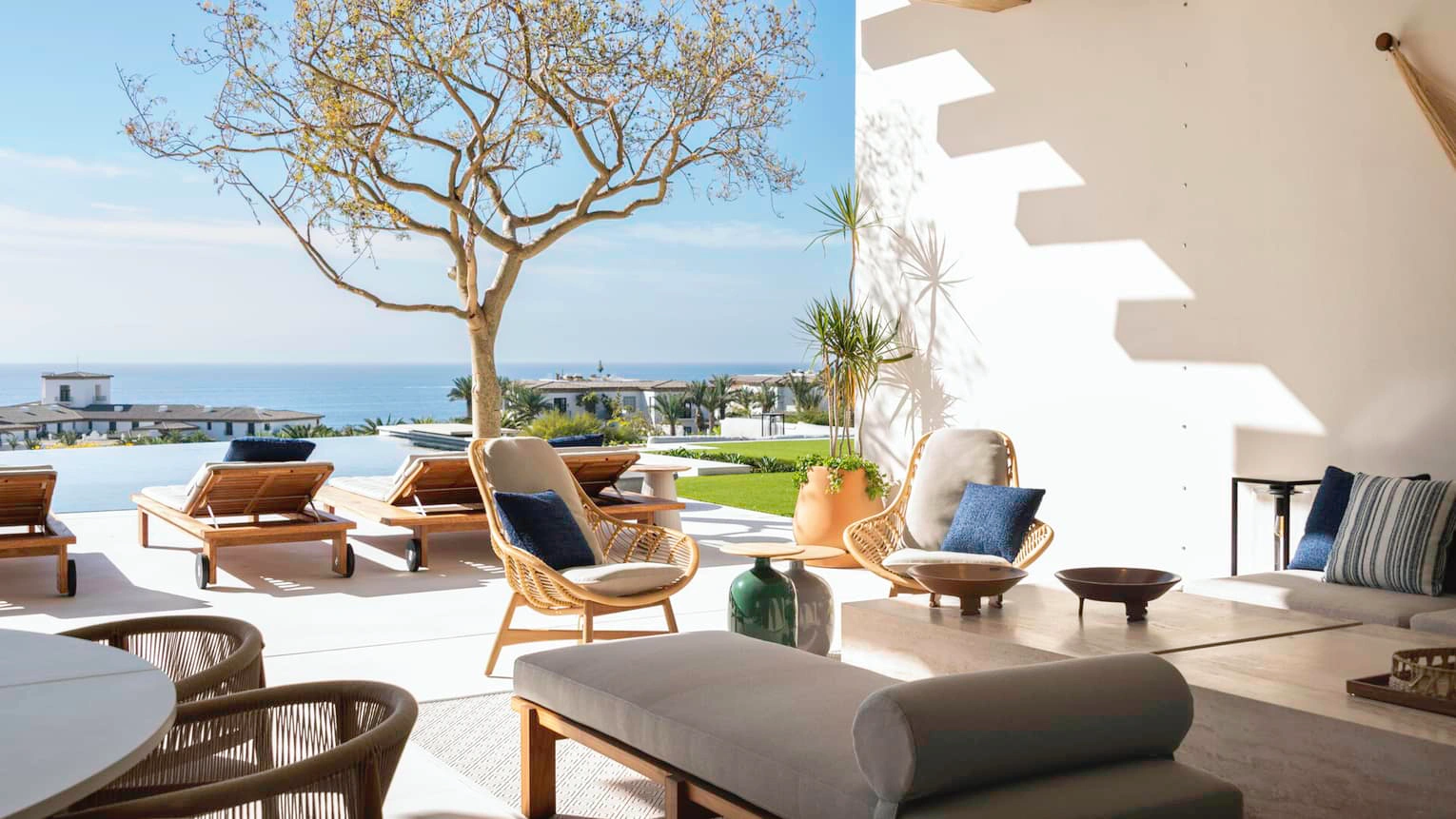 Seaside living architecture luxury coastal hotel interior with elegant design, natural light, ocean-inspired atmosphere, and contemporary Mediterranean style.