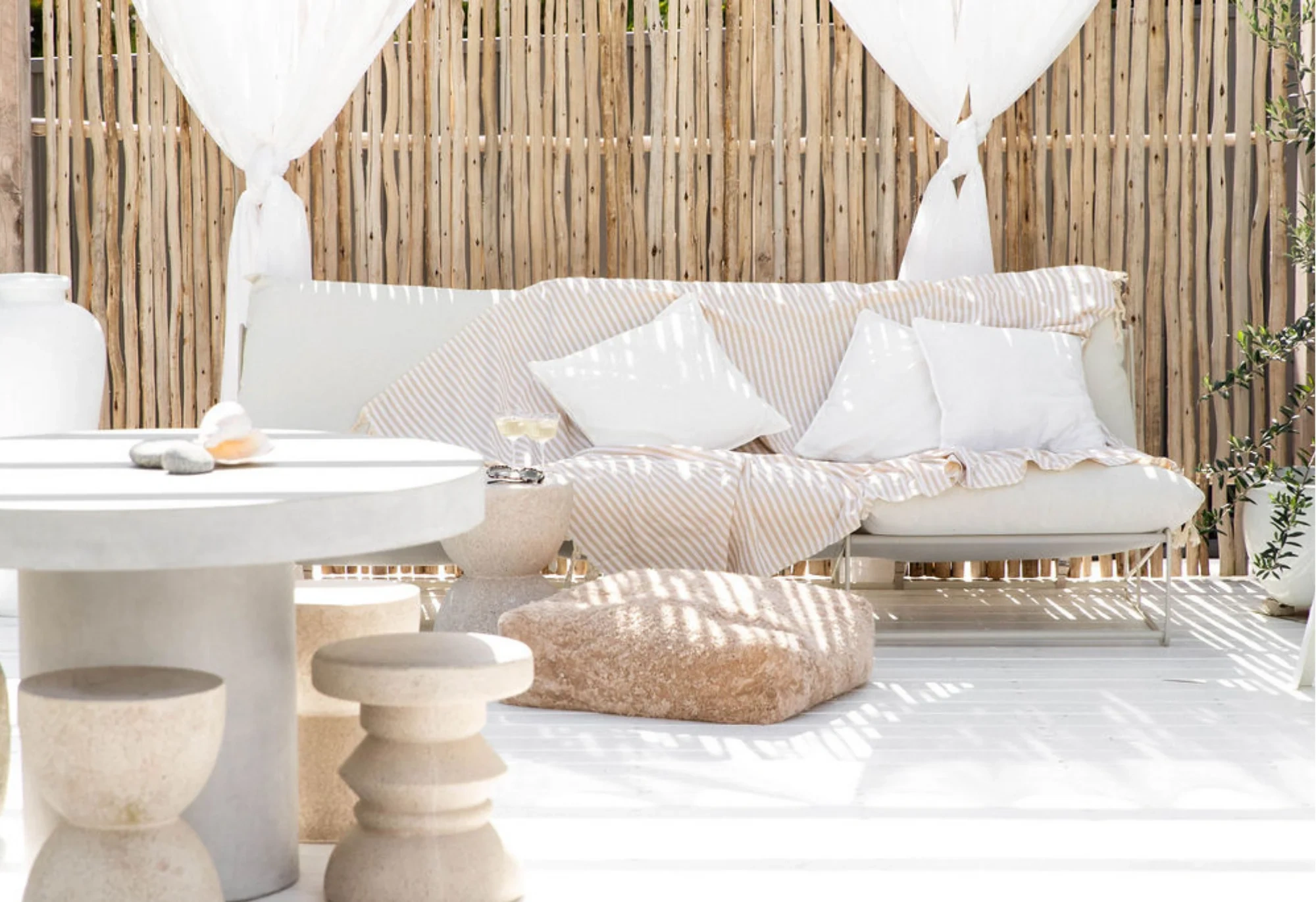 Mediterranean identity interior styling featuring Moroccan cushions, woven textiles, natural materials, and contemporary warm living room decor.