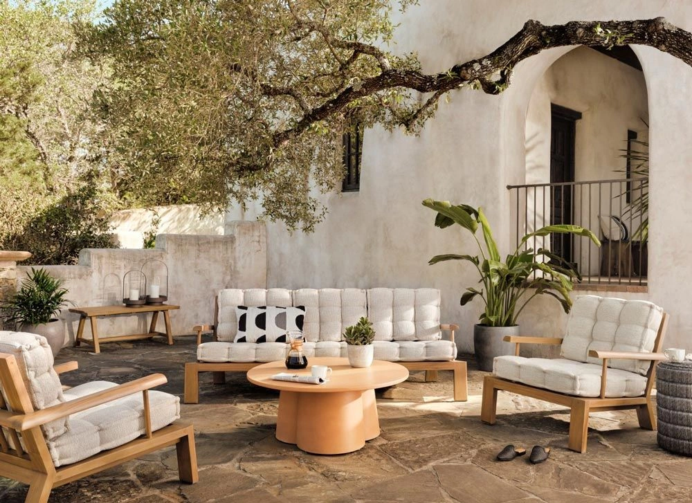 Mediterranean Living interior with natural light, soft neutral tones, organic textures, and contemporary coastal design.