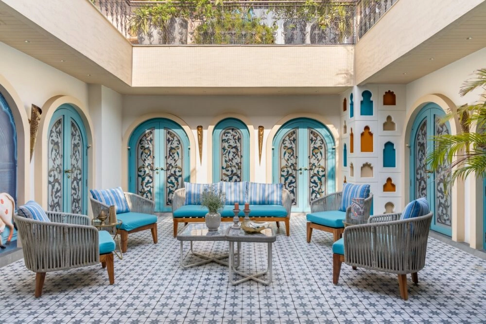 Mediterranean interior design featuring natural stone, warm neutral tones, wooden textures, and contemporary modern interiors inspired by coastal lifestyle.