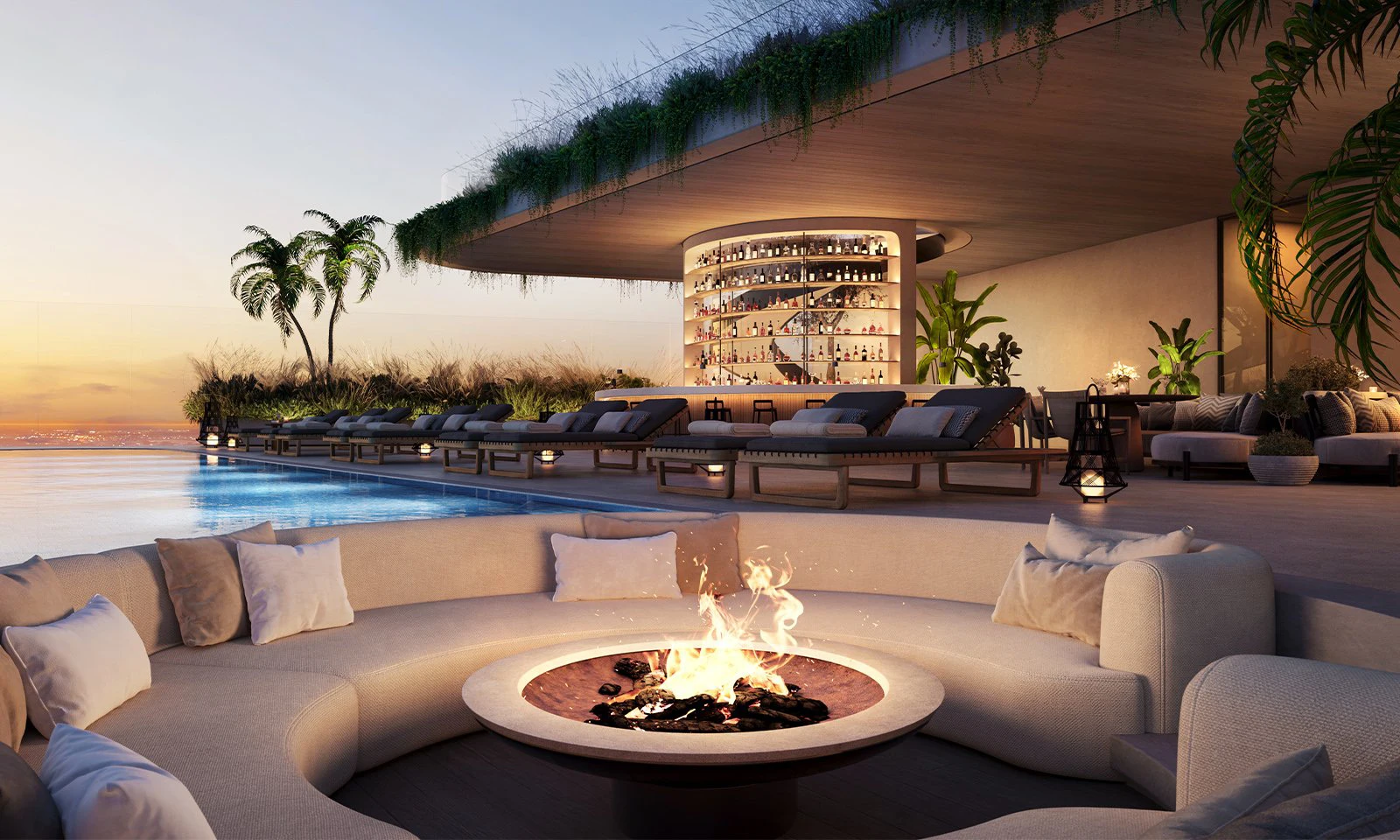 Luxurious outdoor lounge by ORA by Casa Tua with a central fire pit surrounded by plush seating. Infinity pool, palm trees, bar with shelves, and sunset view create a serene, upscale ambiance. 