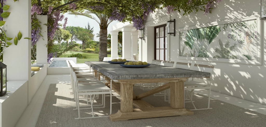 A serene outdoor patio in a residential project by Pedro Peña with a long wooden table and white chairs under a vine-covered pergola.