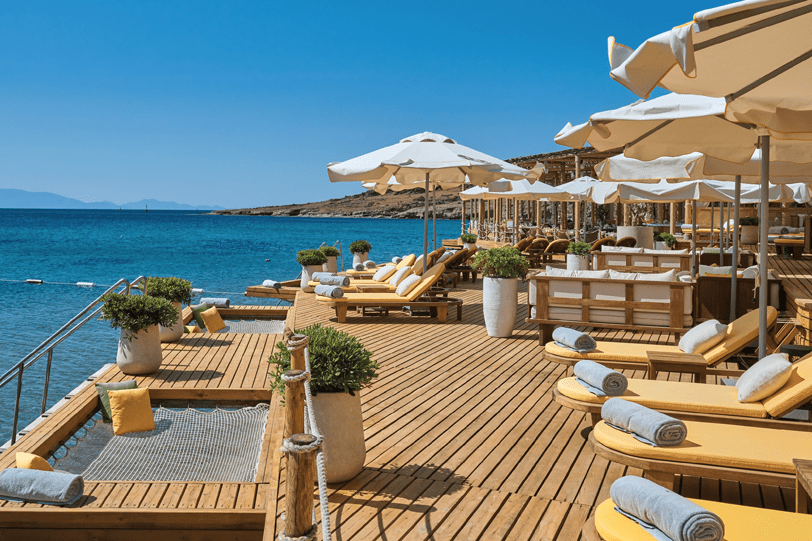 Mediterranean Travel Experiences showcasing an outdoor terrace with sea views, natural materials, and sophisticated hospitality design.