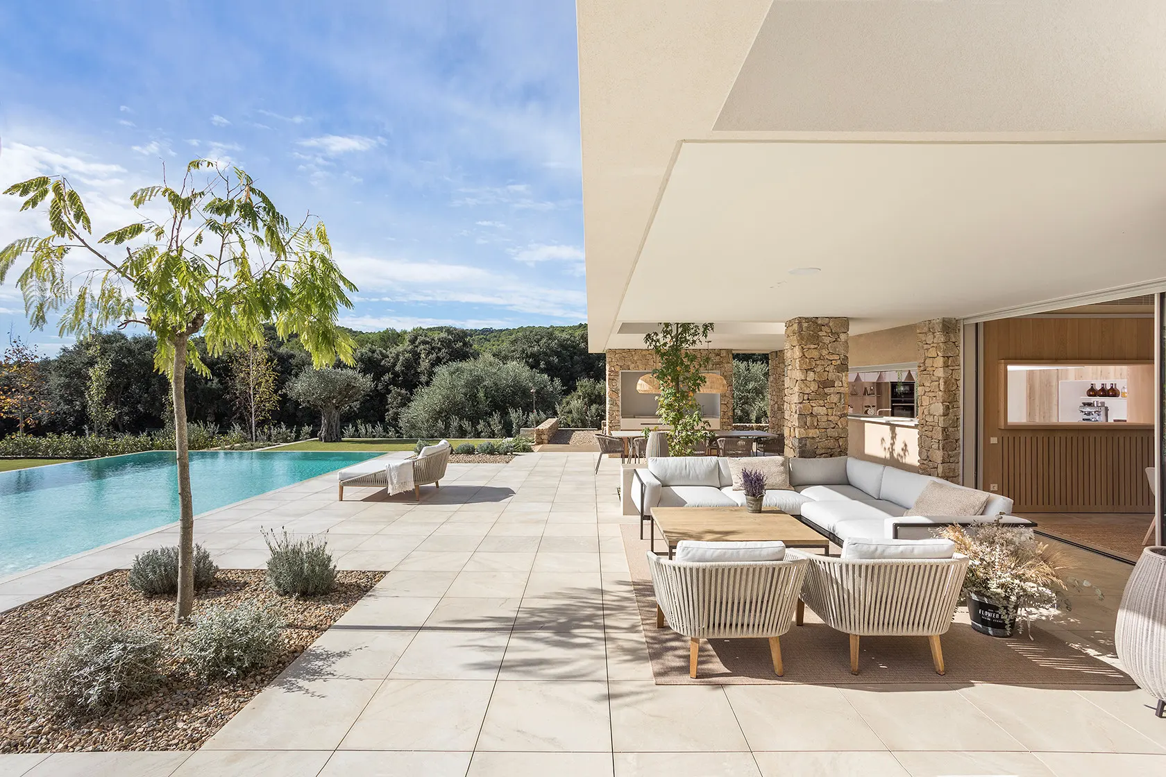 Outdoor Luxury Design featuring a Mediterranean outdoor lounge with natural stone, premium furniture, and elegant open-air living.