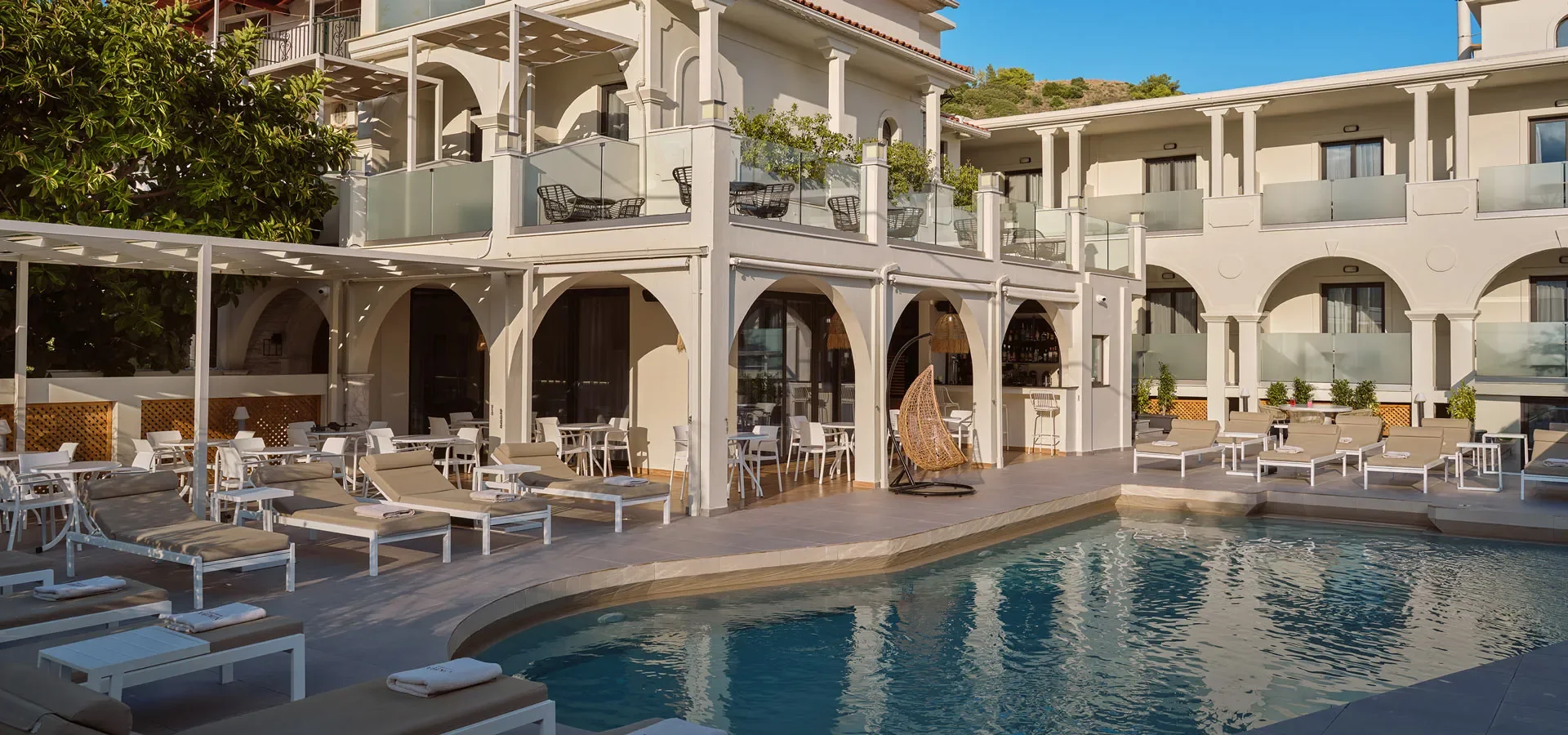 Mediterranean Travel Experiences featuring a boutique hotel courtyard with natural stone, local craftsmanship, and timeless Mediterranean architecture.