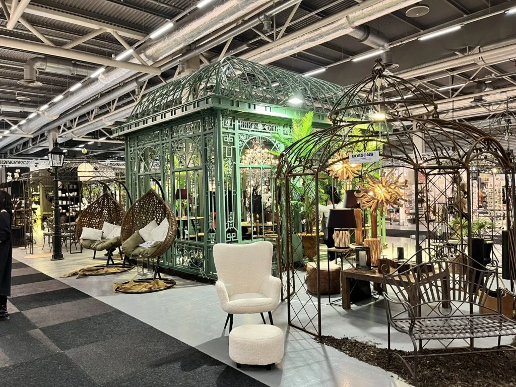 Ornate green iron gazebo and outdoor garden furniture display at the Formex trade fair.
