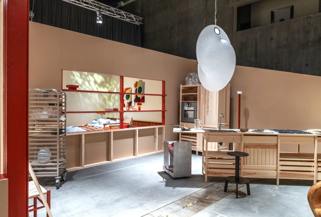 Scandinavian wooden kitchen trend exhibition setup with sculptural pendant lighting at Oslo Design Fair.